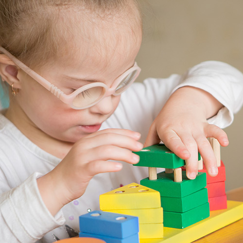 Photo of little girl with learning difficulties playing